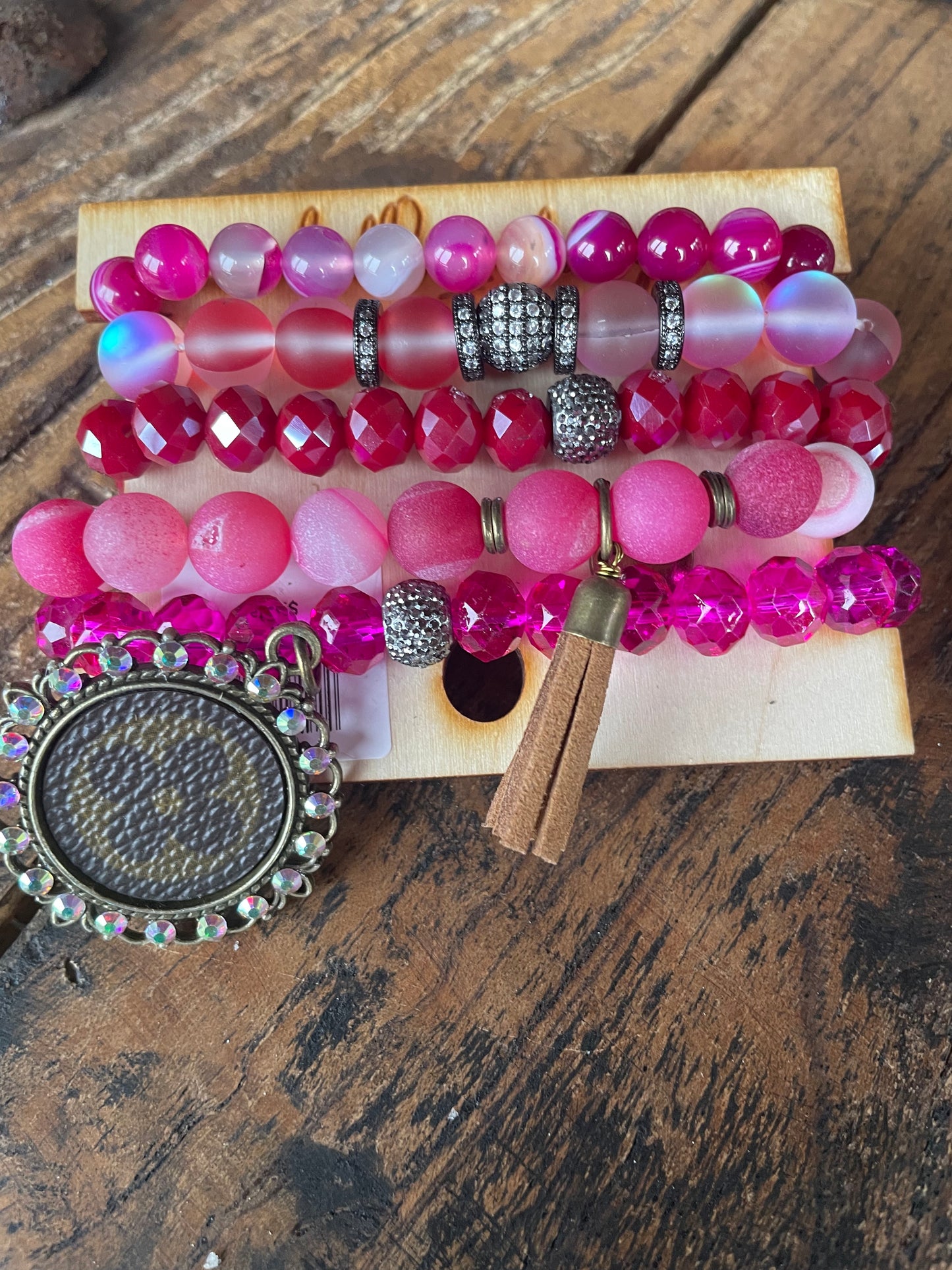 Hot Pink Bracelet stack with upcycled emblem